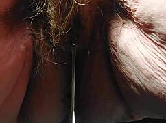 oma inserts cucumber into her hairy pussy for some fun