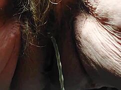 oma inserts cucumber into her hairy pussy for some fun