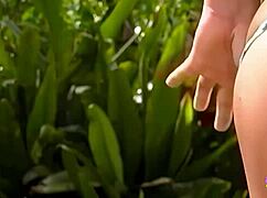 An ebony lesbian queen in a bikini screws her redhead alluring foxy girlfriend outdoors