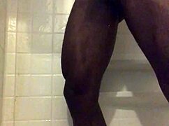 He strokes his monster black cock in the homemade shower solo.