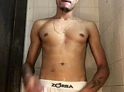 Young guy with thick cock strokes off in steamy shower bath