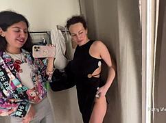 two brunettes sneak kisses in the public locker room