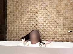 cute skinny japanese brunette bathes in luxury hotel shower