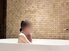 cute skinny japanese brunette bathes in luxury hotel shower