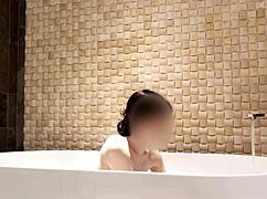 cute skinny japanese brunette bathes in luxury hotel shower