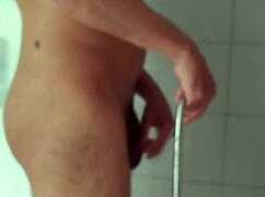 big dick guy carefully shaves his massive penis in bathroom mirror