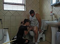 Humiliated milf slut kneels sucking cock desperately on toilet