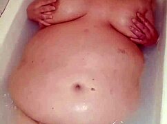 naked bbw milf fingers her big wet pussy deep in bathtub