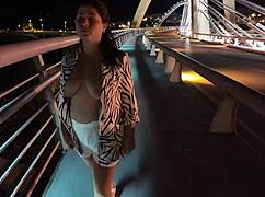 Milf parades braless pantyless across risky bridge.