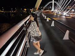 Milf parades braless pantyless across risky bridge.