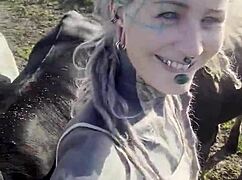 happy hippie chats cows while flashing tattooed body