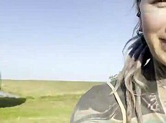 happy hippie chats cows while flashing tattooed body