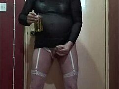 Crossdressing sissy slurps piss cum mix from glass