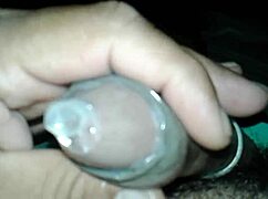 guy strokes his small cock solo with condom on tight