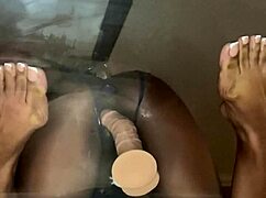 Ebony Elegance rams dildo deep in pussy