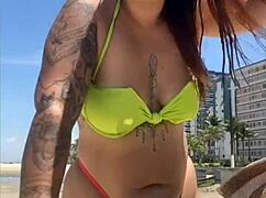 casada flashing tiny bikini on beach calling attention with exhibitionist moves