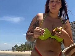 casada flashing tiny bikini on beach calling attention with exhibitionist moves