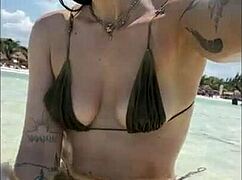 Nympho redhead babe fingers creamy sand-covered pussy on beach