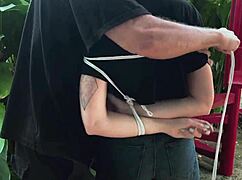 teasing her pretty feet with some playful punishment outdoors