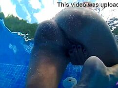 A mature blonde couple dives into steamy pool sex on a sunny day