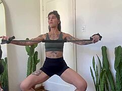 inked babe stretches with rubber bands in sfw yoga workout