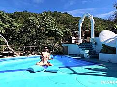 tattooed latina fingers her big pussy lips then takes monster cock doggystyle by pool