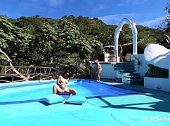 tattooed latina fingers her big pussy lips then takes monster cock doggystyle by pool