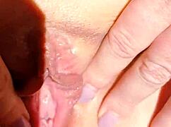 mature woman in dress spreads her smooth shaved pussy on cam