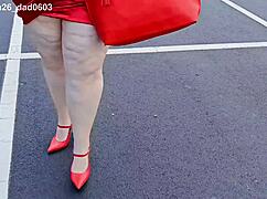 beautiful woman walking outdoors in public parking lot showing off for strangers
