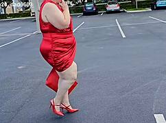 beautiful woman walking outdoors in public parking lot showing off for strangers