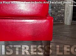 Goddess teases feet in socks under desk