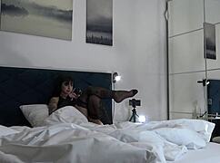 Hot brunette changes panties under her skirt on bed