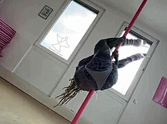 Anuskatzz dances on the pole with goth energy